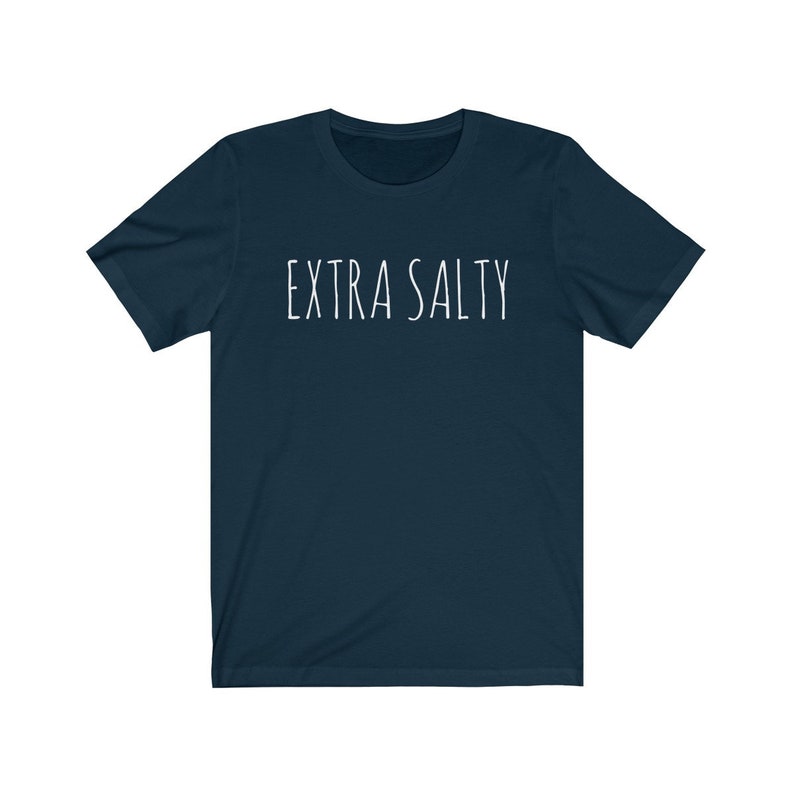 May include: A dark blue t-shirt with the text "EXTRA SALTY" printed in white on the front.