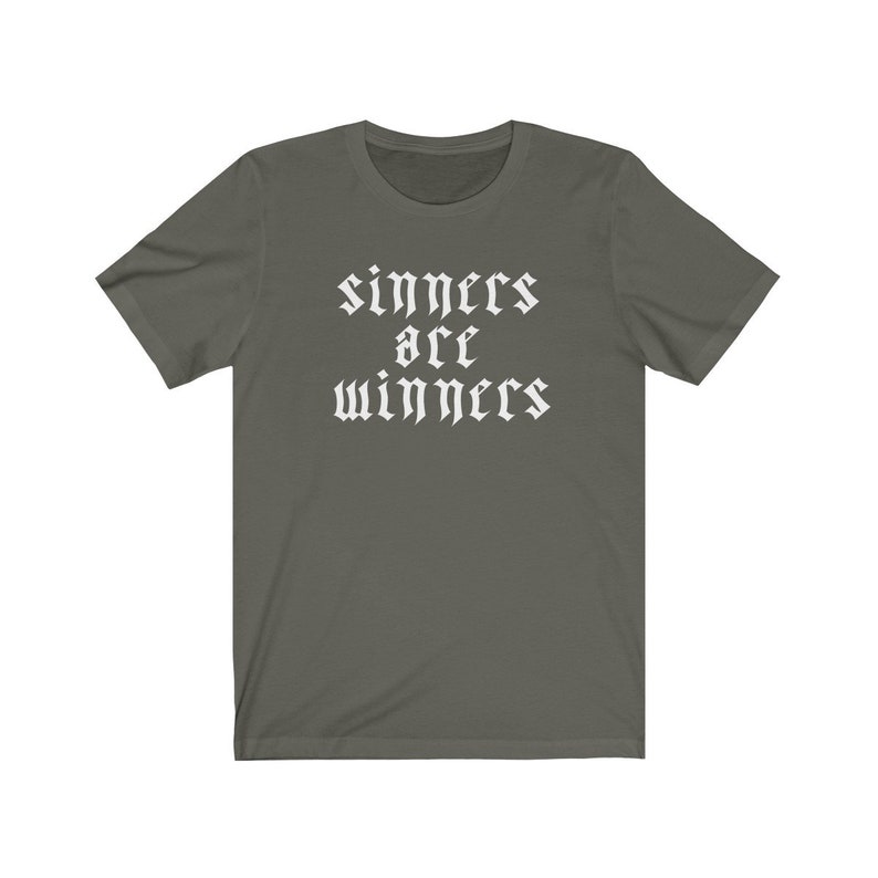 May include: A dark green t-shirt with white text that reads "sinners are winners" in a gothic font.