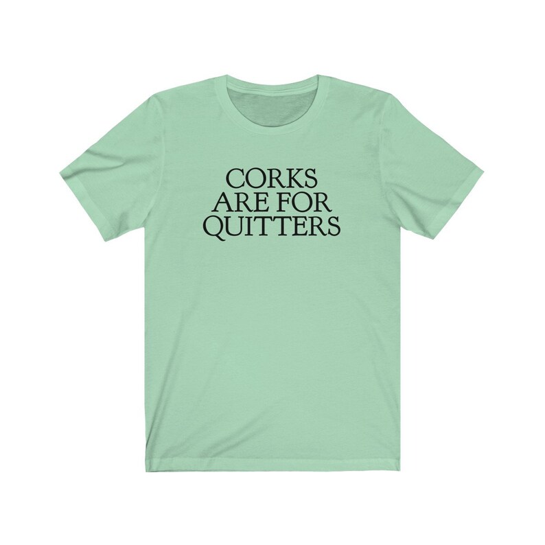 May include: A light green t-shirt with the text "CORK ARE FOR QUITTERS" printed in black.