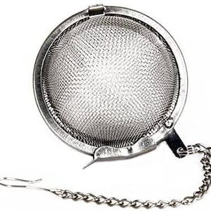 May include: A silver tea infuser with a fine mesh ball and a chain attached. The infuser has a spring-loaded lid that opens and closes.