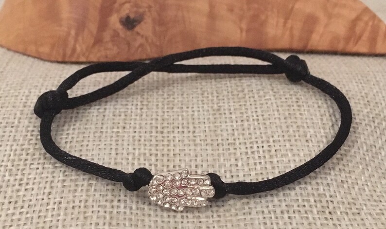 Hamsa hand of Fatima silver bracelet set with Rhinestones adjustable black cord