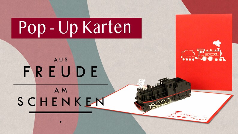 Puede incluir: Una tarjeta roja pop-up con un modelo 3D negro de un tren. La tarjeta est&aacute; abierta y el tren est&aacute; saliendo. La parte delantera de la tarjeta tiene una silueta blanca de un tren. El texto en la tarjeta dice "Pop-Up Karten aus Freude am Schenken".