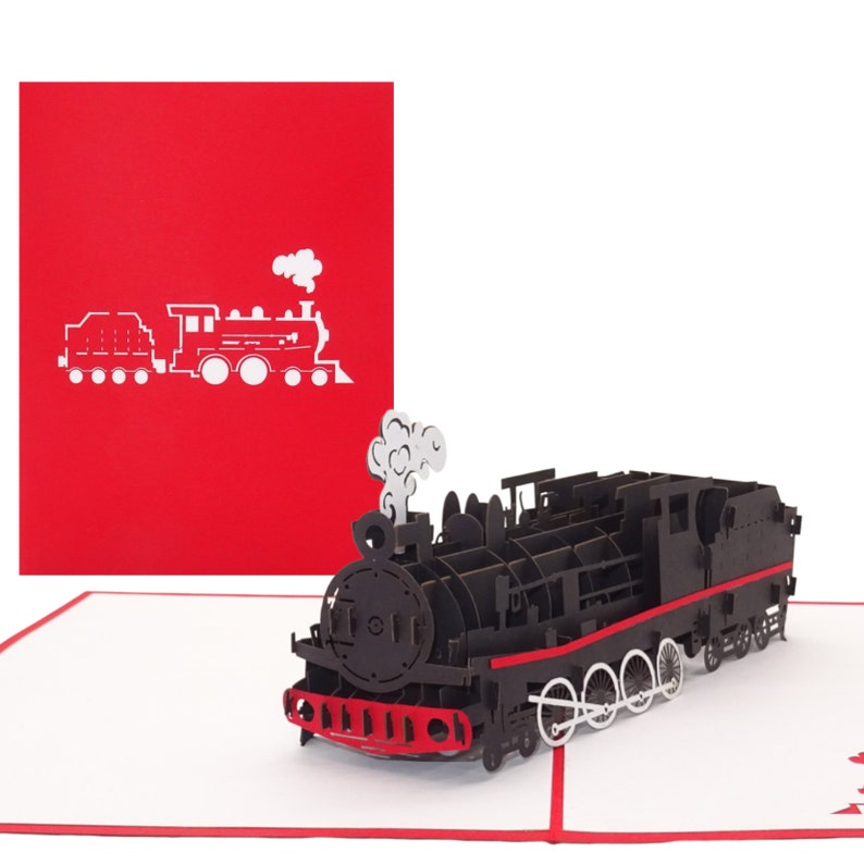 Puede incluir: Una tarjeta pop-up 3D negra con un modelo detallado de un tren de vapor vintage con detalles rojos. La tarjeta est&aacute; cerrada y muestra una silueta simple de un tren sobre un fondo rojo.