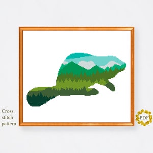 May include: Cross stitch pattern of a beaver silhouette filled with a green forest and blue sky landscape.
