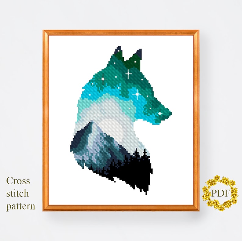 May include: A cross stitch pattern featuring a wolf silhouette with a mountain and starry sky inside. The wolf is outlined in black and the sky is a gradient of blue and green.