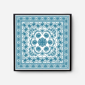 May include: A framed square print with a blue and white geometric pattern. The pattern features a central motif of a stylized flower with repeating floral designs around the border.