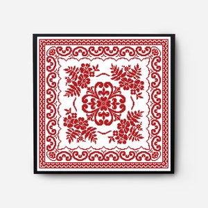 Op de afbeelding: Een rood en wit kruissteekpatroon met een bloemenmotief in een zwart frame.