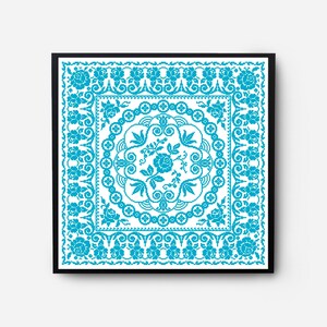 May include: A framed cross-stitch design featuring a blue floral pattern with a white background. The design is intricate and detailed, with a central motif of a flower surrounded by leaves and swirls.