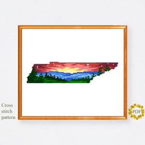 May include: Cross stitch pattern of the state of Tennessee with a sunset over a lake and mountains. The sky is a gradient of red, orange, and yellow. The lake is blue and the mountains are green.
