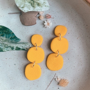 Textured organic pebbles in Deep Orange | statement slow made colourful polymer clay dangle earrings | Gifts for her