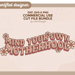 May include: A pink and white graphic design with the text "MIND YOUR OWN MOTHERHOOD" in a retro font style. The design is surrounded by small pink flowers.