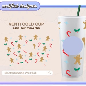 Puede incluir: Un vaso frío blanco de 24 onzas con un diseño navideño. El vaso presenta hombres de jengibre, bastones de caramelo, acebo y copos de nieve. El texto "VENTI COLD CUP" y "24OZ | DXF, SVG & PNG" está impreso en el vaso.