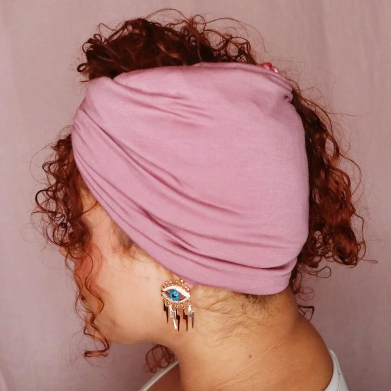 Mauve Afronain the pineapple style with curls on the sides.