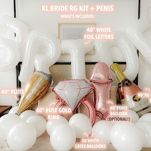 Extra large white letters spelling BRIDE hang above the bed in an arch. Below the letters on the bed rests four large complementing foil balloons, a large flute, a rose gold ring, a champagne bottle and 20 white round balloons