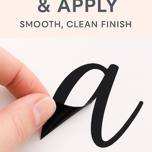 May include: A black vinyl letter 'a' is being peeled from a white surface. The text 'EASY PEEL & APPLY' and 'SMOOTH, CLEAN FINISH' are displayed in grey above the letter.