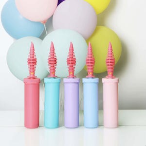 May include: Five balloon pumps in different colors: pink, blue, light purple, light blue, and pink. The pumps have a spiral design and are made of plastic.