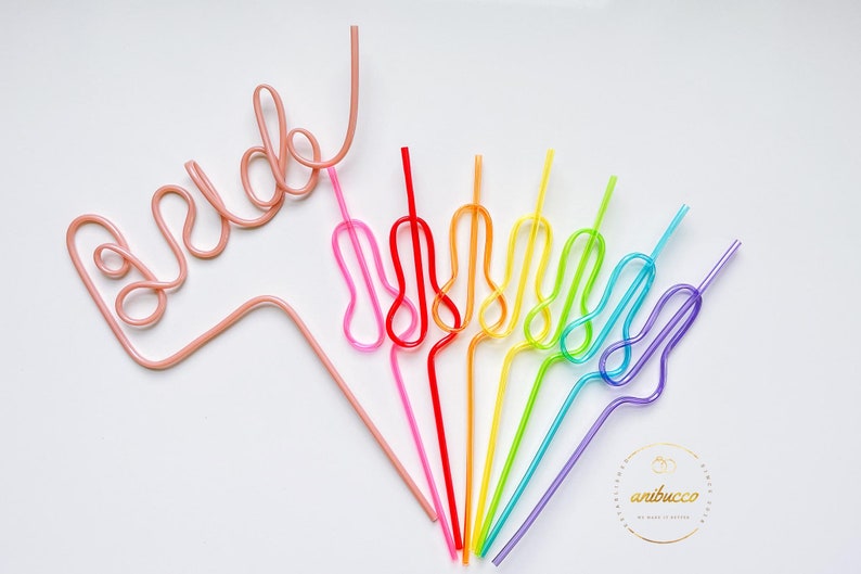 May include: A set of rainbow colored reusable drinking straws, bent into a heart shape. One pink straw is bent into the word "bride".