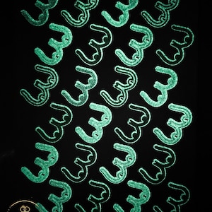 May include: A black background with a repeating pattern of green, stylized, cursive letter 'W's.
