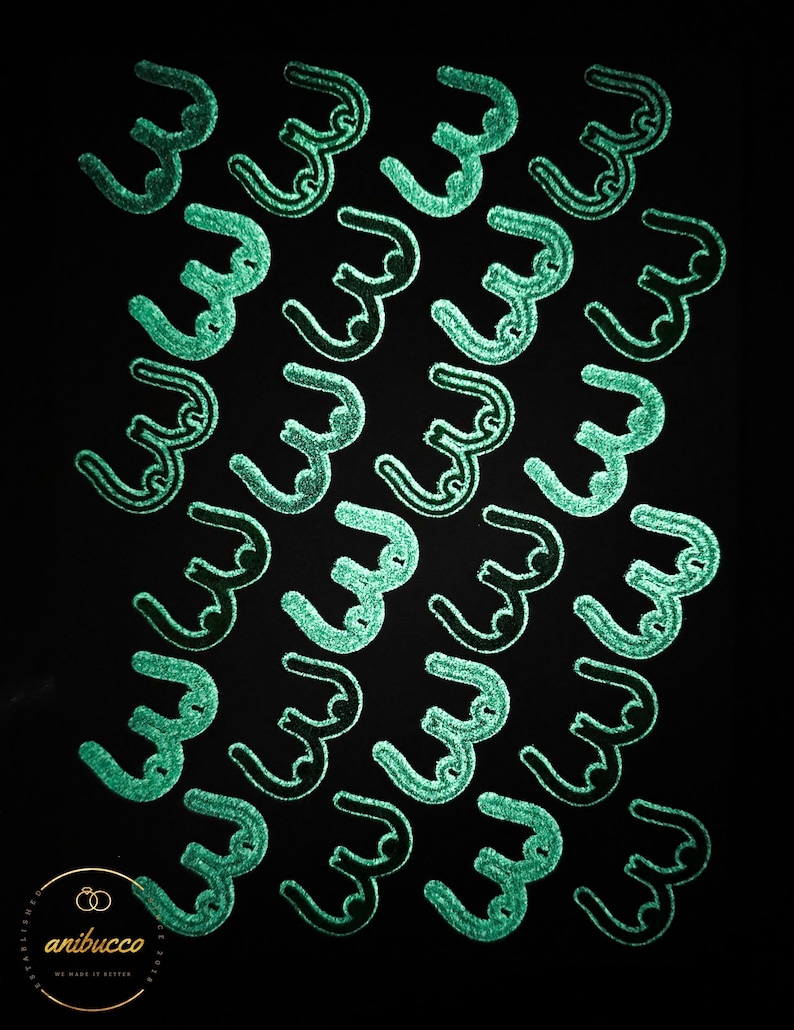 May include: A black background with a repeating pattern of green, stylized, cursive letter 'W's.