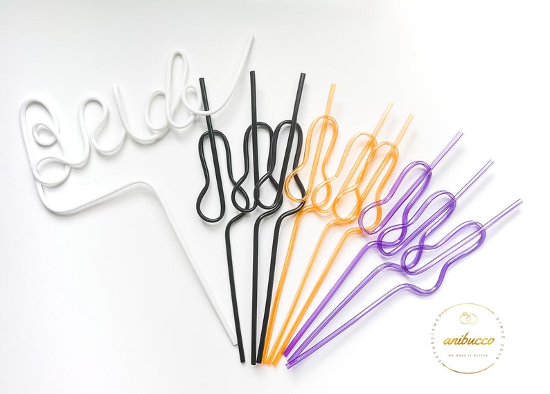 May include: A set of colorful, bendable drinking straws in white, black, orange, purple, and pink. The straws are shaped into a fun, whimsical design.