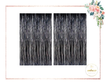 May include: Two silver foil curtains, each measuring approximately 3 feet wide and 8 feet tall, are hung side-by-side. The curtains are made of thin, shimmering strips of foil that hang vertically.