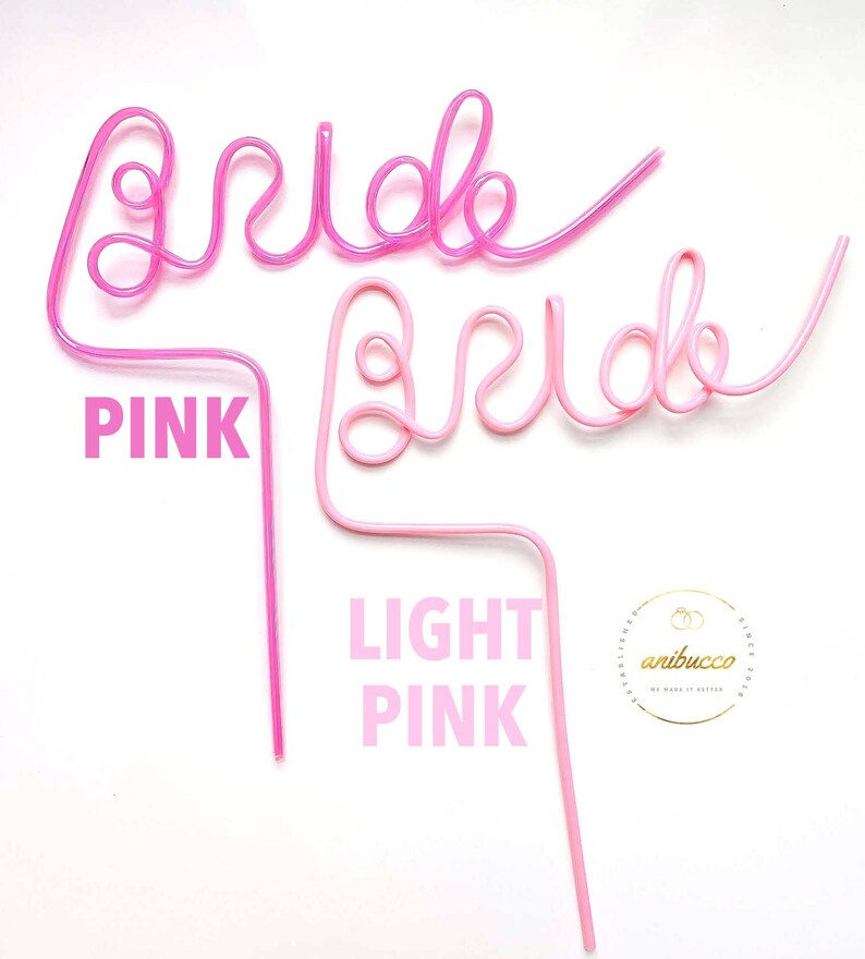 May include: Two pink plastic straws shaped to spell out the word "bride". The top straw is a darker pink and the bottom straw is a lighter pink. The straws are on a white background.