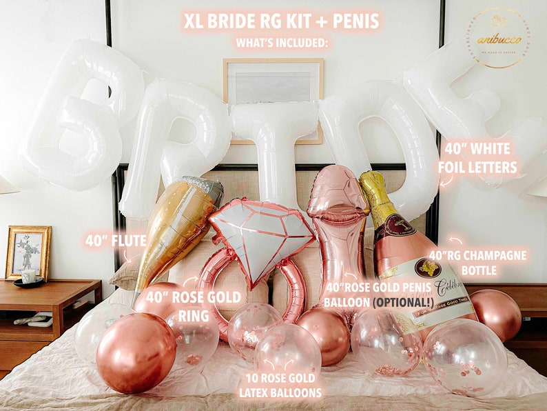 Extra large white letters spelling BRIDE hang above the bed in an arch. Below the letters on the bed rests four large complementing foil balloons, a large flute, a rose gold ring, champagne bottle and 10 rose gold chrome and confetti filled balloons