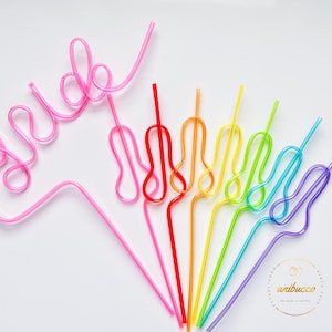 May include: A set of rainbow colored bendy straws with one pink straw shaped to spell "bride".