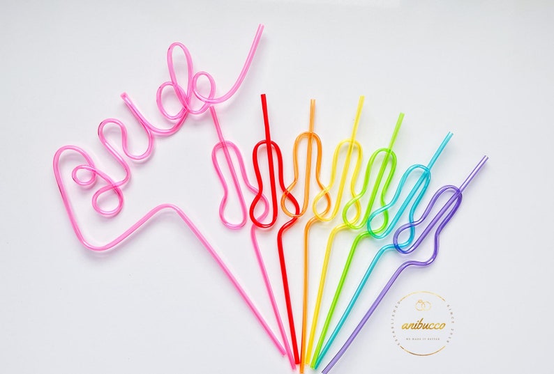 May include: A set of rainbow colored bendy straws with one pink straw shaped to spell "bride".