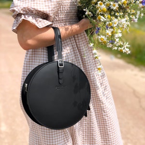 Structured circle crossbody bag. Black leather round bag