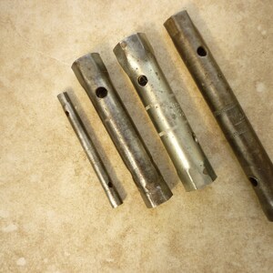 May include: Four silver pipe wrenches of different sizes, with one wrench marked "1/2" and another marked "3/4".