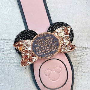 May include: A gold glitter bow with black ears and a brown circle with the text "Here you leave today and enter the world of yesterday, tomorrow and fantasy" on a pink background.
