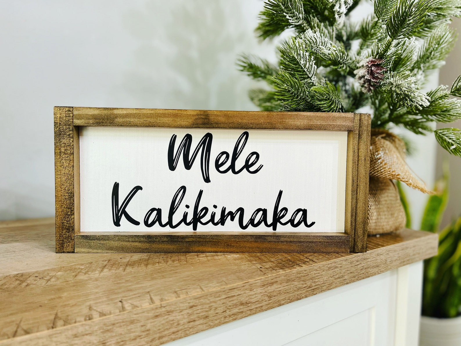 Best Hawaiian Christmas Decorations featured by top Hawaii blogger, Hawaii Travel with Kids: Add some Hawaiian Christmas decorations to your home this holiday season with these top Hawaii Christmas decorations ideas from top Hawaii blog Hawaii Travel with Kids. Image of Hawaiin Christmas Sign that says Mele Kalikimaka