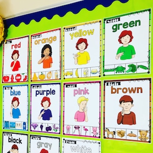 May include: A classroom bulletin board with colorful cards featuring different colors, each with a person signing the color in American Sign Language. The cards also include pictures of objects in the corresponding color. The colors featured are red, orange, yellow, green, blue, purple, pink, brown, black, gray, and white.