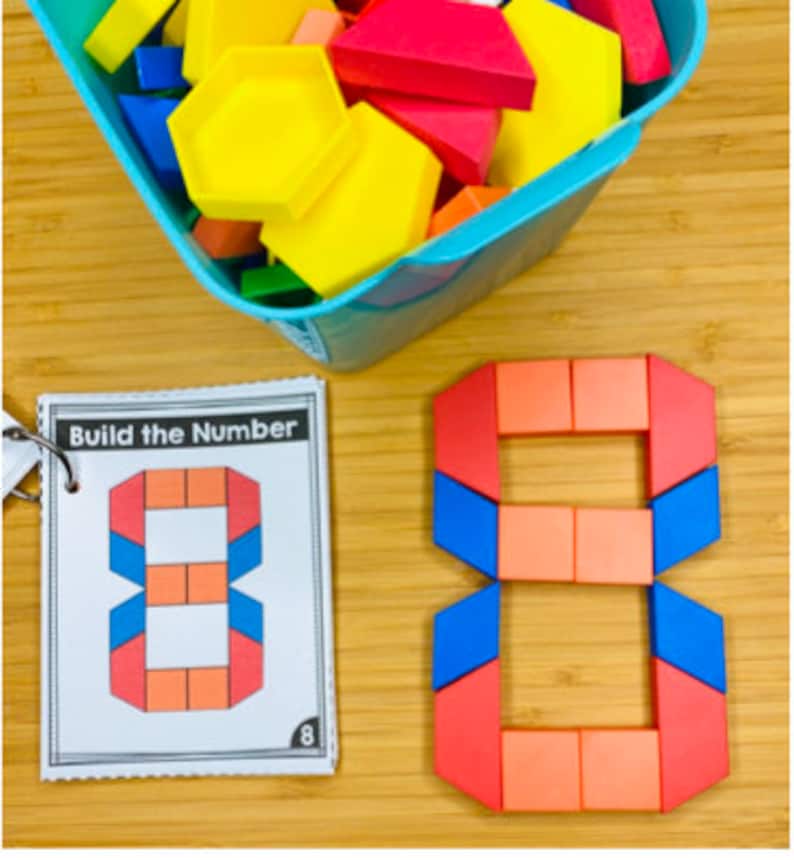 May include: A colorful wooden number eight made from geometric shapes. The number eight is made from red, orange, and blue blocks. The number eight is on a wooden surface. The image also shows a book with the words "Build the Number" on the cover.