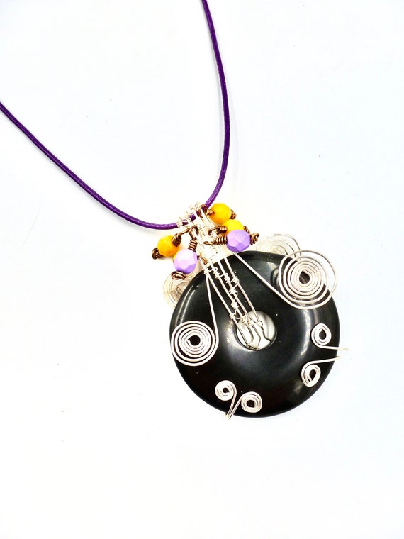 Black Stone Silver Wire Wrapped Donut Pendant With Purple and Yellow Beaded Accents On Purple Cord Necklace by Lauren Jay Designs