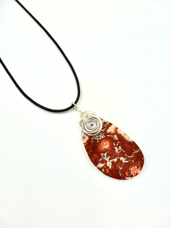 Red Spotted Stone Pendant With Silver Wire Wrapped Spiral Detail On Black Cord Necklace by Lauren Jay Designs