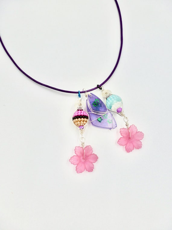 Purple Resin Green Star Pendant With Beaded Floral Accents On Purple Cord Necklace by Lauren Jay Designs