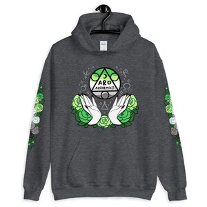 May include: A dark gray hoodie with a green, gray, and white aro alchemist symbol on the front. The symbol is surrounded by green roses and white hands. The sleeves have a pattern of green, gray, and white roses.