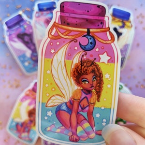 May include: A sticker of a fairy trapped inside a glass bottle. The fairy has brown hair, pink wings, and is wearing a pink and blue outfit. The bottle is decorated with stars and a crescent moon.