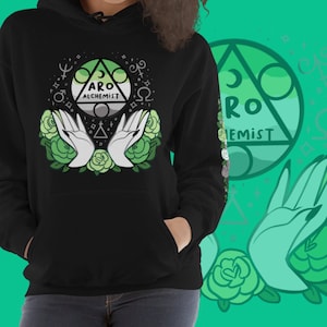 May include: Black hoodie with a green and white aro alchemist symbol surrounded by green roses and hands. The symbol is a triangle with a circle inside and the words "Aro Alchemist" written inside the circle.