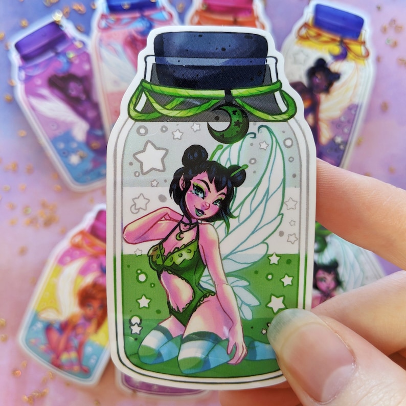 May include: A green glass bottle sticker with a fairy inside. The fairy has green wings, a green and white outfit, and blue and white striped stockings. The bottle has a green lid and a white background with stars and a crescent moon.