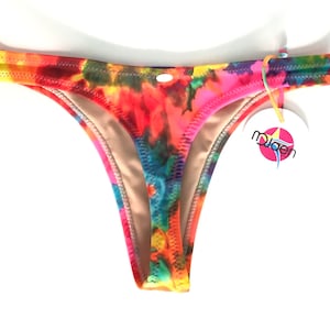 May include: A colourful tie-dye print bikini bottom with a low-rise cut and a small tag that says "mojoen".