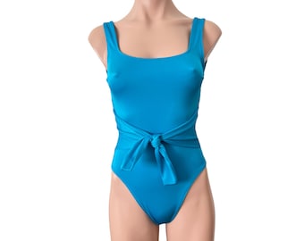 May include: A turquoise swimsuit with a tie at the waist.