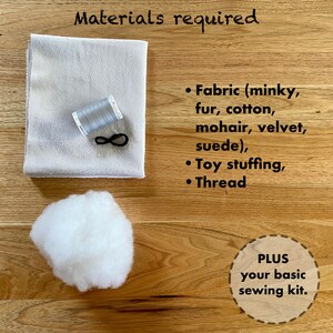 May include: Materials required for a sewing project: a piece of light grey fabric, a reel of grey thread, a black elastic band, a pile of white stuffing, and the text "PLUS your basic sewing kit."