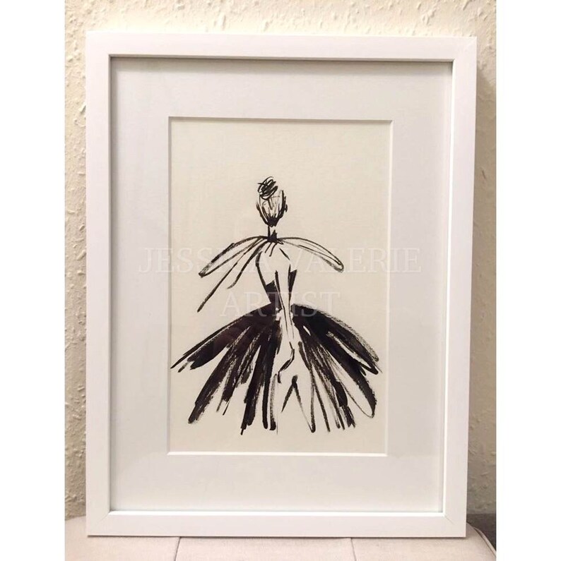 May include: Black and white ink drawing of a person wearing a dress. The drawing is framed in a white frame. The artist's name, "JESSICA ERIE ARTIST", is written in the bottom center of the drawing.
