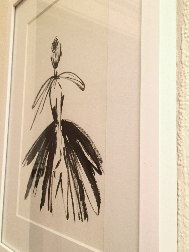 May include: A black and white ink drawing of a person in a dress. The drawing is framed and has a white mat.