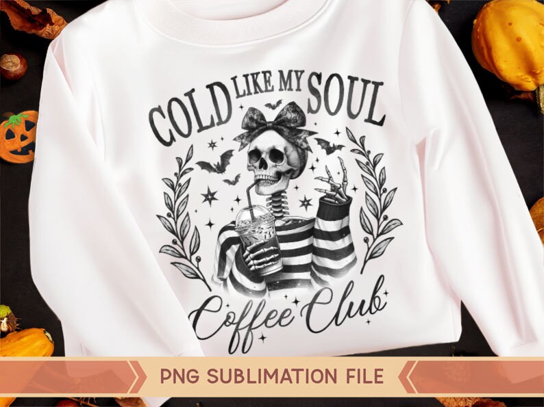 May include: A white sweatshirt with a black and white graphic design of a skeleton holding a cup of coffee. The text on the graphic says "Cold Like My Soul Coffee Club".