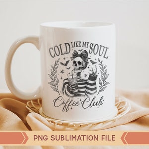May include: White ceramic mug with a black and white illustration of a skeleton holding a cold drink. The text on the mug reads "Cold Like My Soul Coffee Club".