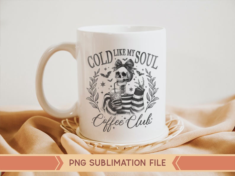 May include: White ceramic mug with a black and white illustration of a skeleton holding a cold drink. The text on the mug reads "Cold Like My Soul Coffee Club".